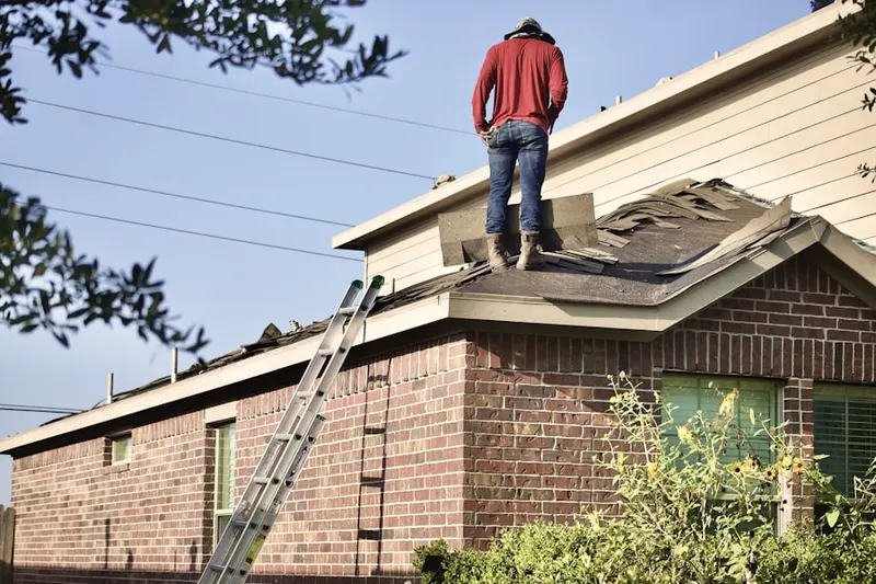 Professional roofer working on a residential roof in Lakeland Shores